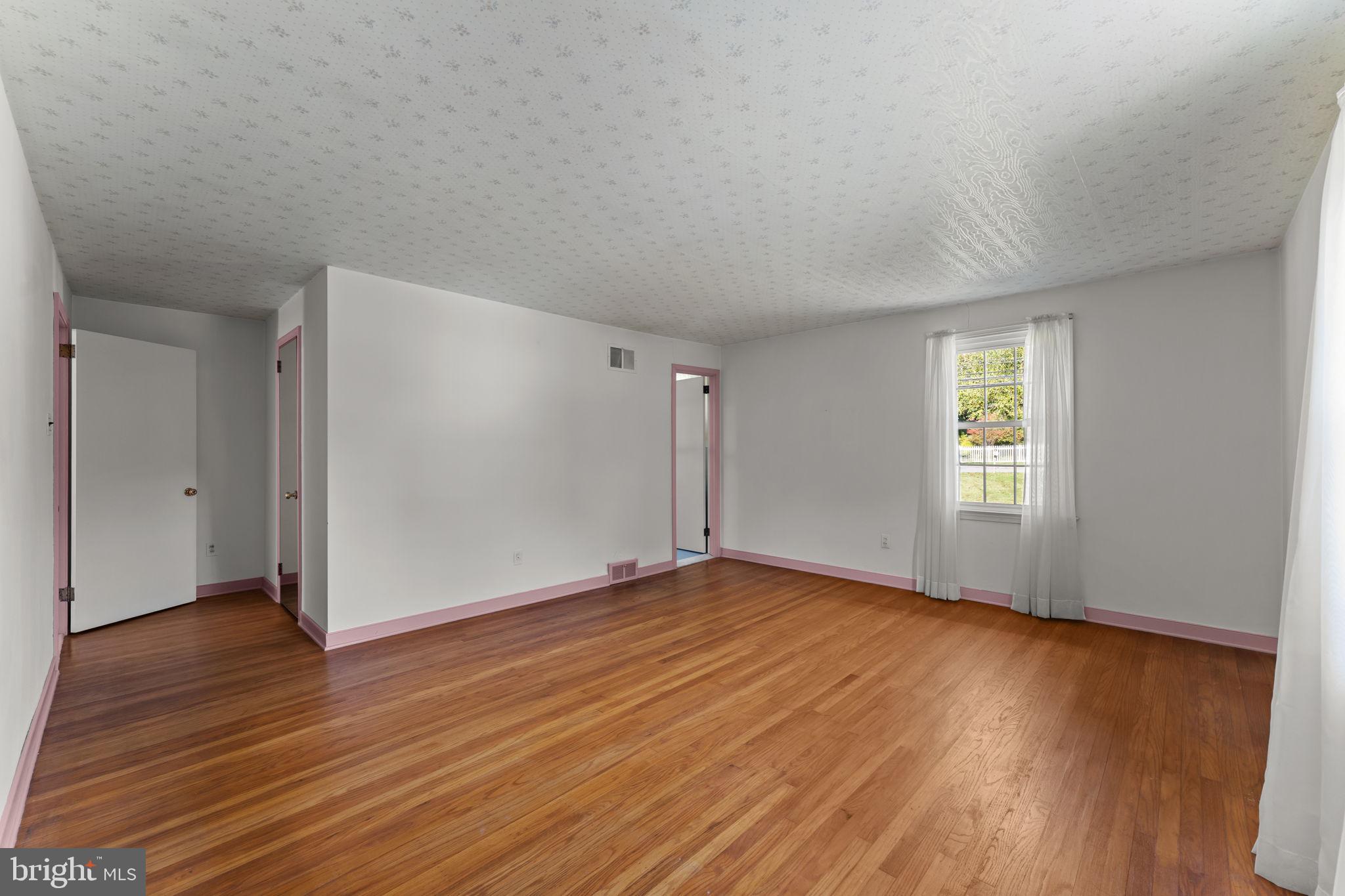 962 Weadley Road Radnor, PA 19087 - Photo 17 of 45 an empty room with wooden floor and windows