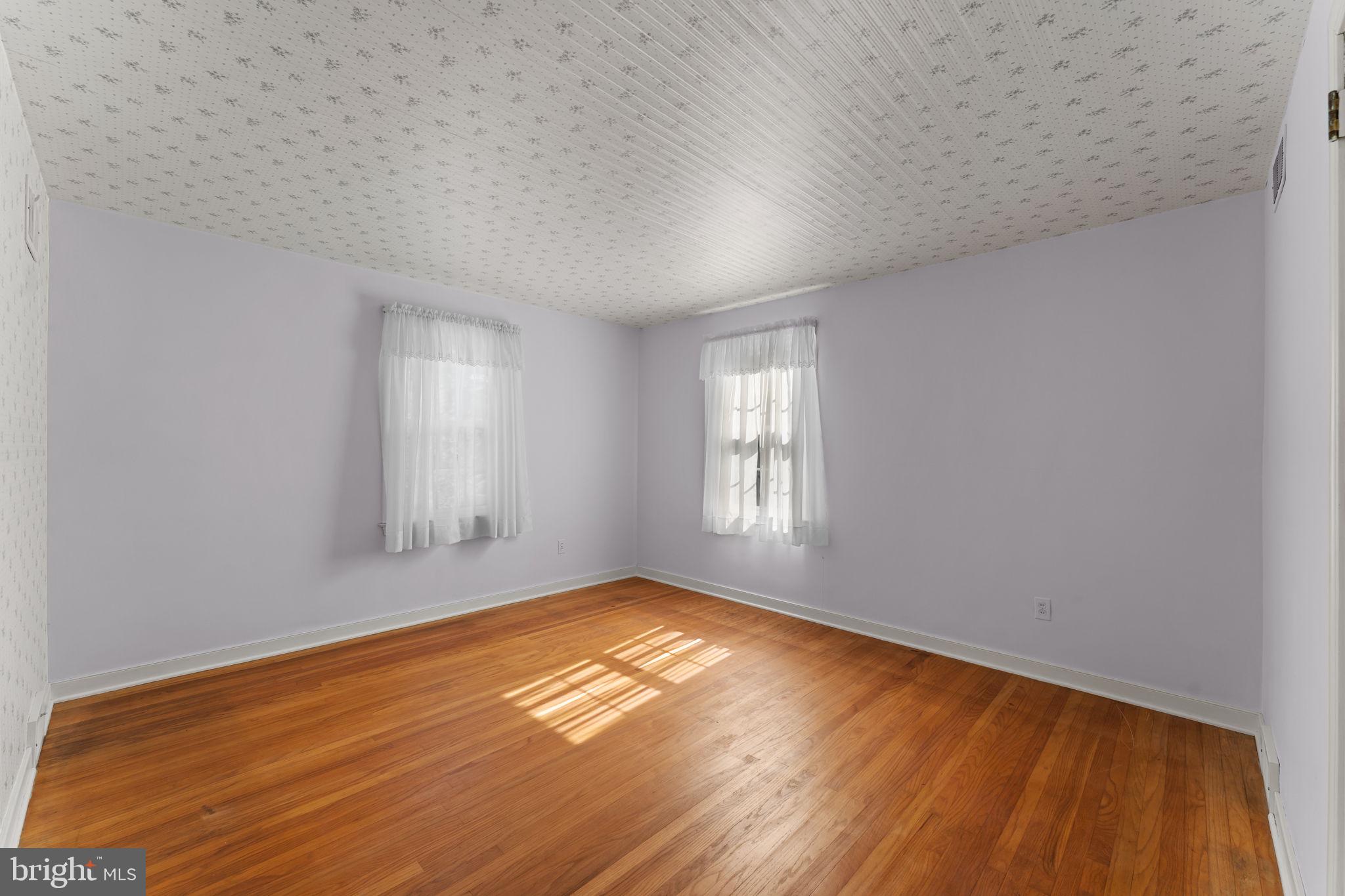 962 Weadley Road Radnor, PA 19087 - Photo 21 of 45 an empty room with wooden floor and windows