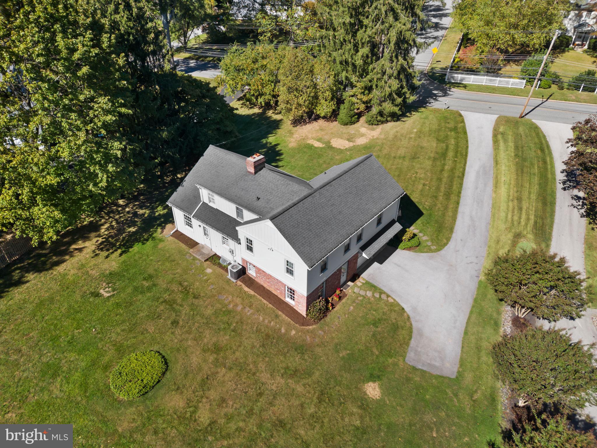 962 Weadley Road Radnor, PA 19087 - Photo 33 of 45 an aerial view of a house with swimming pool and large trees