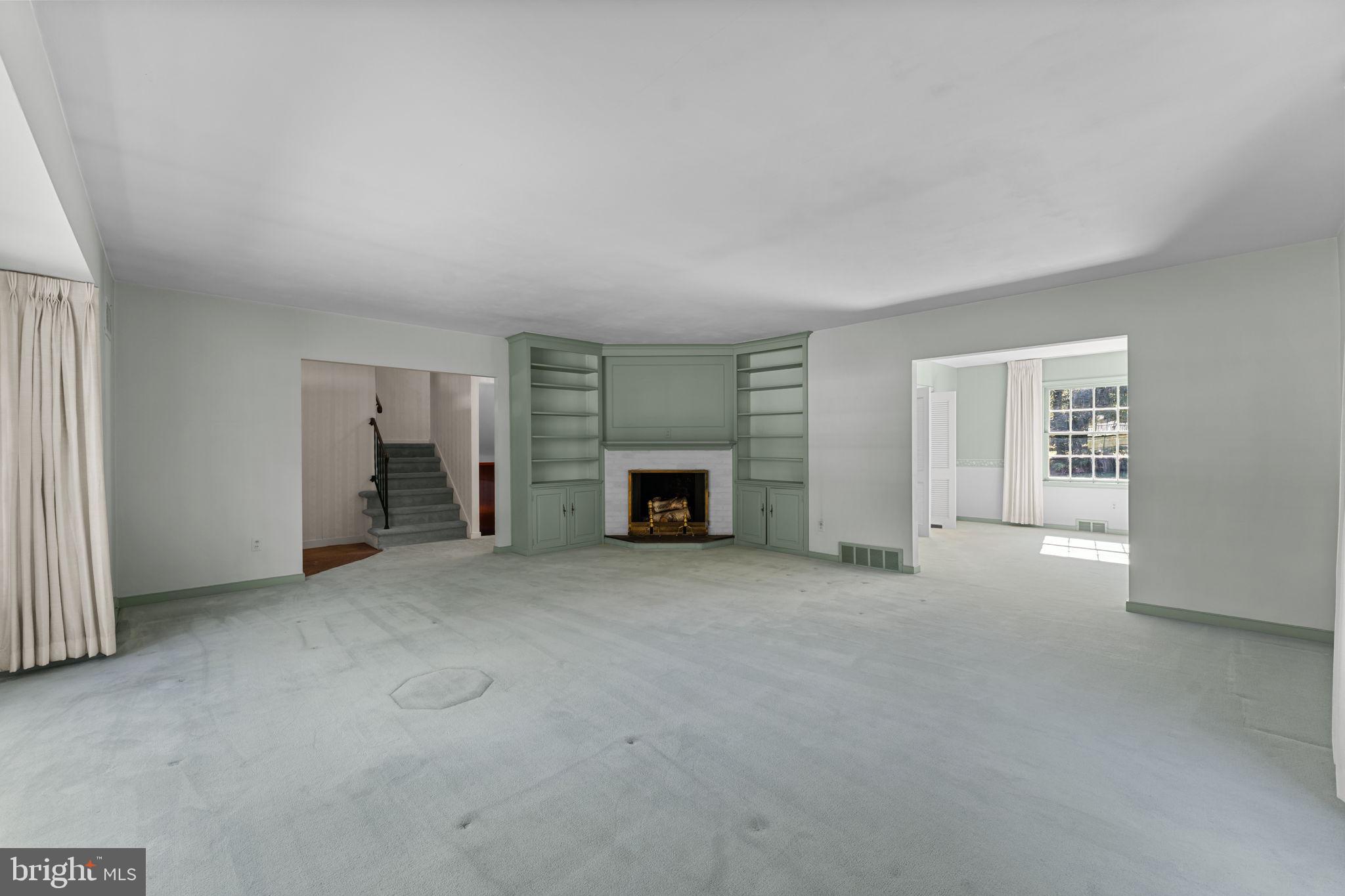 962 Weadley Road Radnor, PA 19087 - Photo 7 of 45 an empty room with furniture and a fireplace