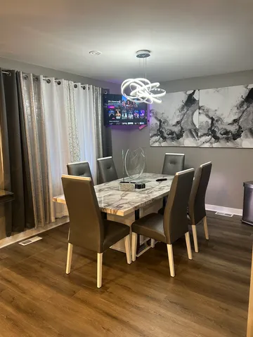 a view of a dining room with furniture and wooden floor