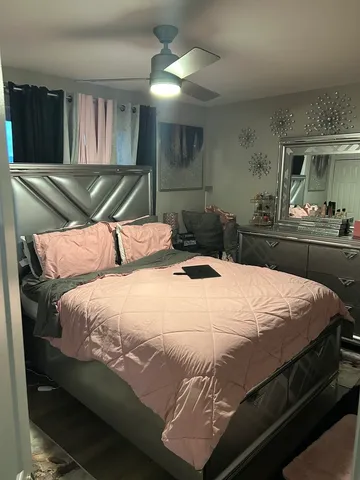 a bedroom with a bed and a large mirror