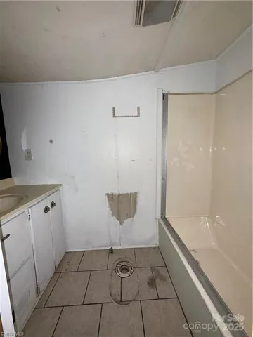 a kitchen with granite countertop a sink a stove and refrigerator