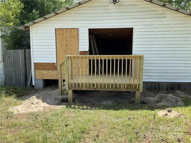 a view of a small yard with wooden fence