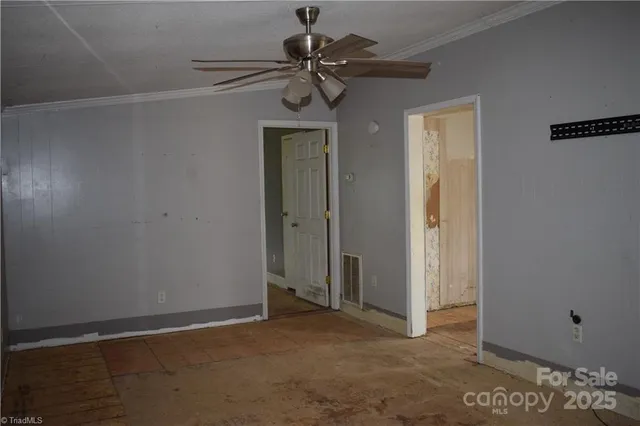 a view of a livingroom with a chandelier fan
