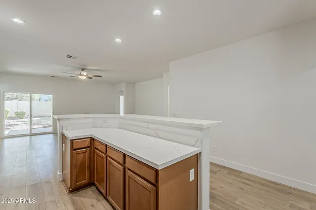 a open kitchen with white cabinets and stainless steel appliances