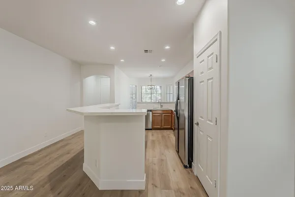 a kitchen with kitchen island a sink and a stove top oven