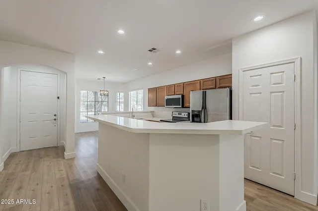 a kitchen with stainless steel appliances a sink stove and microwave