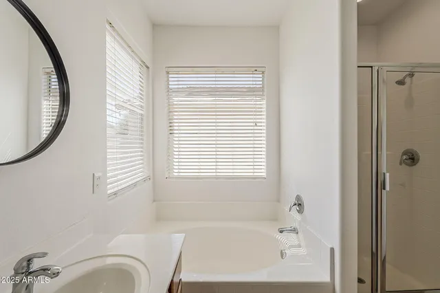 a bathroom with a bathtub and a shower