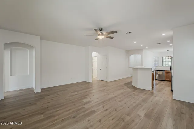 a view of a livingroom with a hardwood floor and a ceiling fan