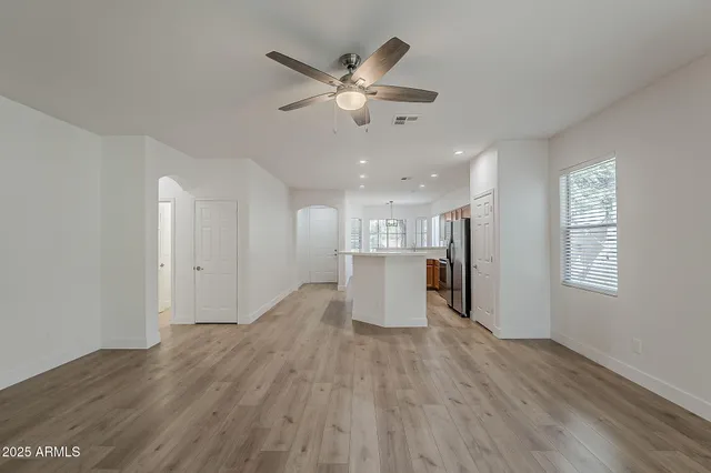 a view of a kitchen with wooden floor and a kitchen space with a sink