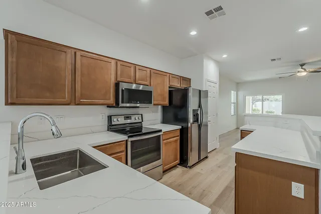 a kitchen with a refrigerator stove and microwave