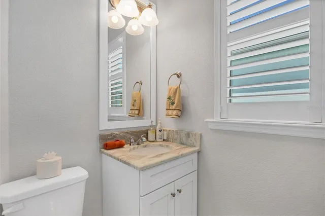 a bathroom with a sink a vanity and a mirror