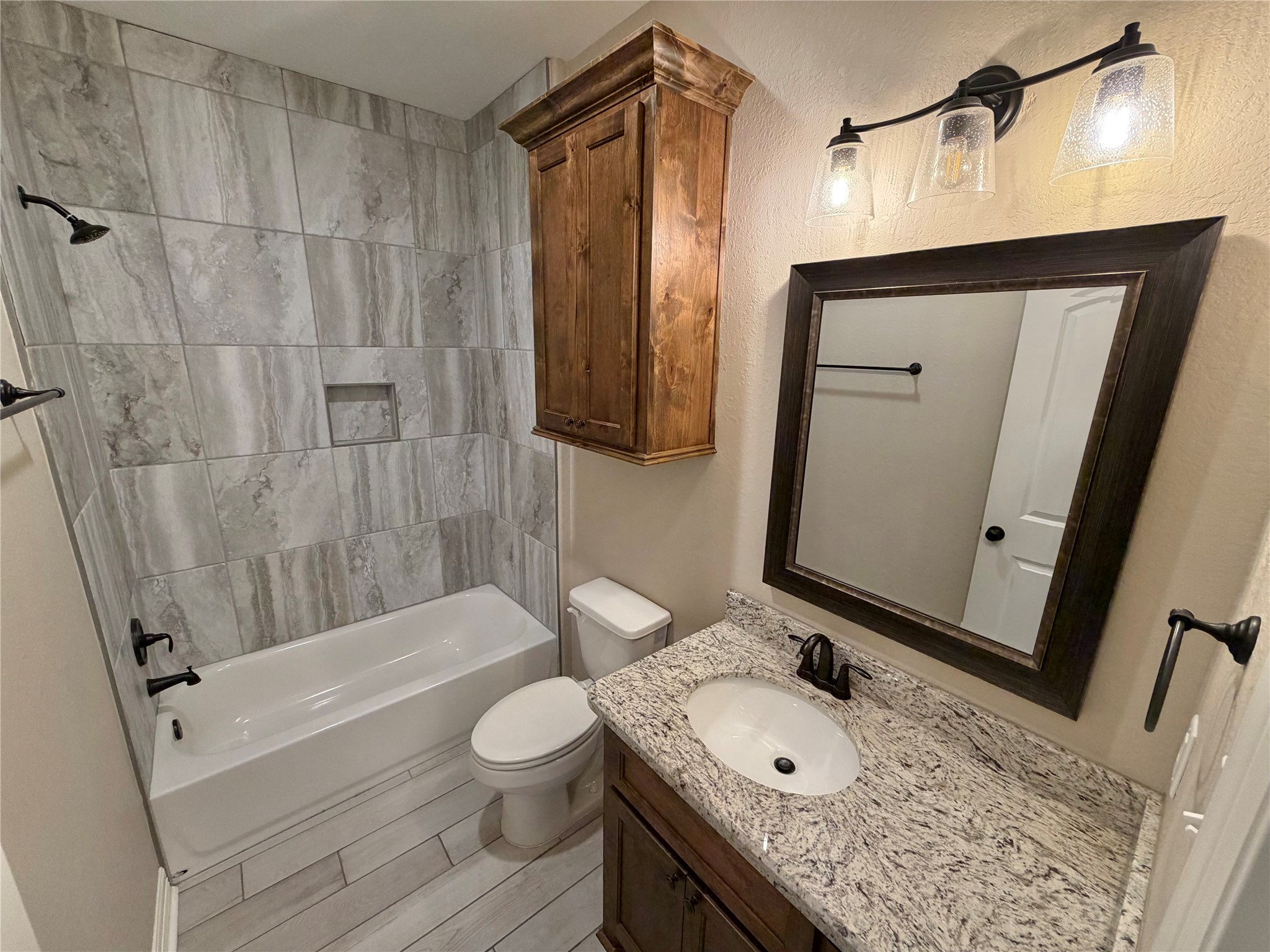 216 Shannon Street Angleton, TX 77515 - Photo 16 of 26 a bathroom with a granite countertop sink toilet and shower