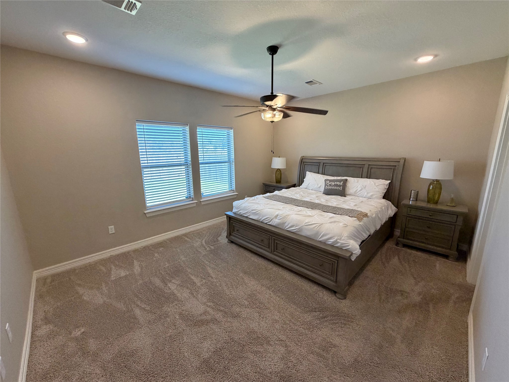 216 Shannon Street Angleton, TX 77515 - Photo 19 of 26 a bedroom with a bed and a chandelier
