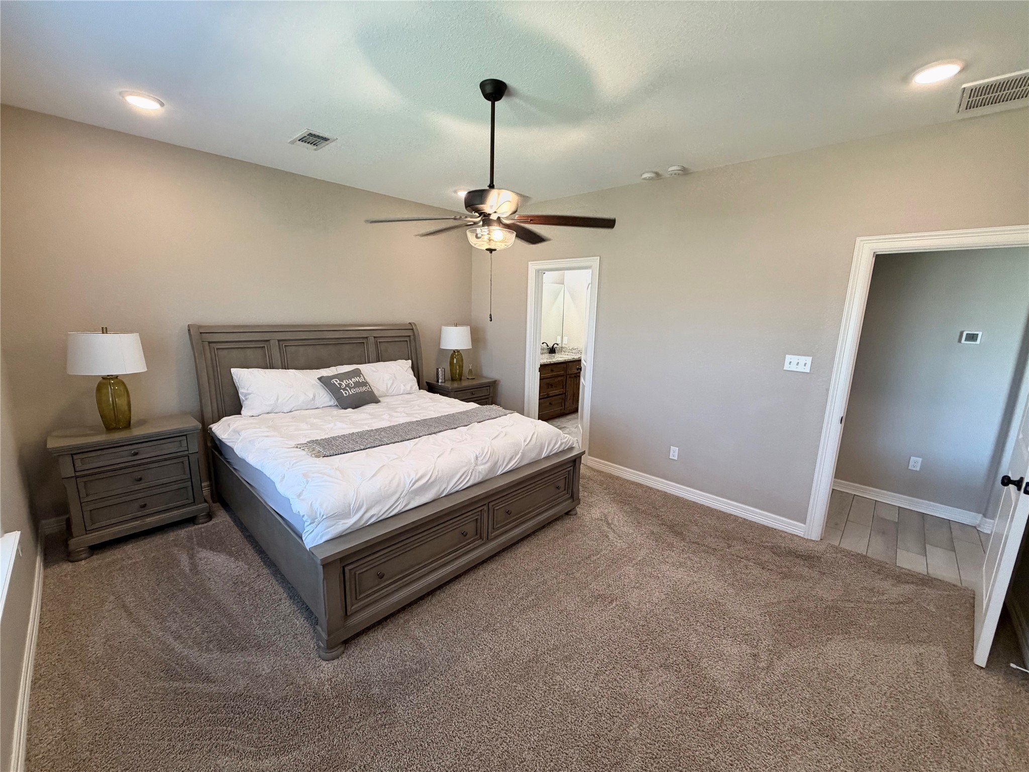216 Shannon Street Angleton, TX 77515 - Photo 21 of 26 a bedroom with a bed and a chandelier