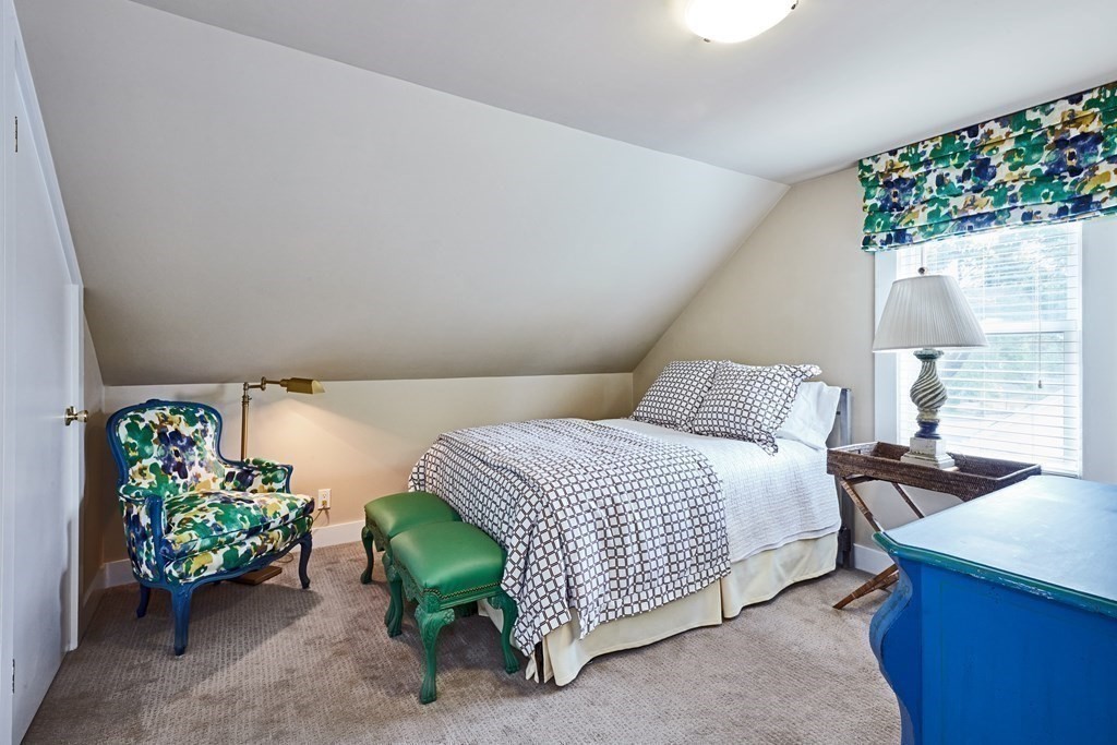 42 Buckmaster Road Westwood, MA 02090 - Photo 19 of 27 a bedroom with a bed and a table