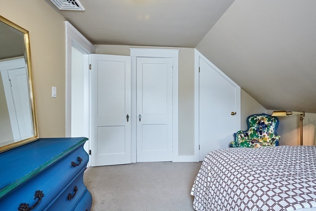 42 Buckmaster Road Westwood, MA 02090 - Photo 20 of 27 a bedroom with a bed and wooden floor