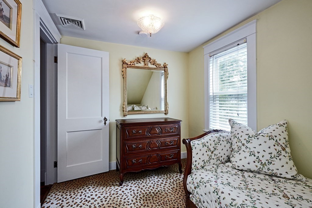 42 Buckmaster Road Westwood, MA 02090 - Photo 22 of 27 a living room with a bed and furniture
