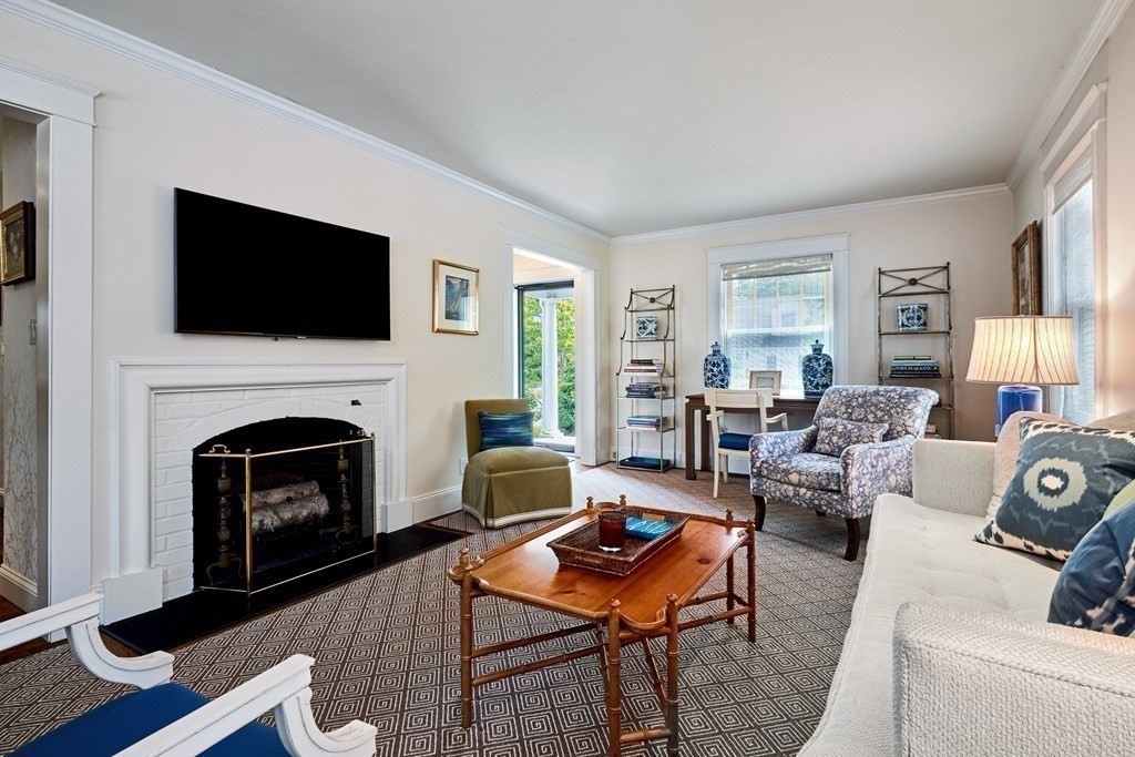 42 Buckmaster Road Westwood, MA 02090 - Photo 7 of 27 a living room with furniture a fireplace and a flat screen tv