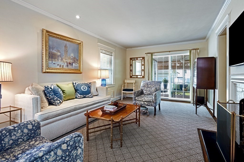 42 Buckmaster Road Westwood, MA 02090 - Photo 9 of 27 a living room with furniture a flat screen tv and a window