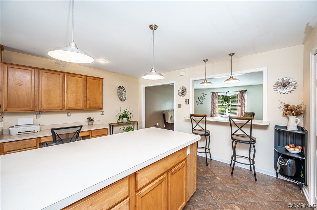 4202 Gladewater Road Henrico, VA 23294 - Photo 14 of 49 a large kitchen with kitchen island a large counter space a sink appliances and cabinets
