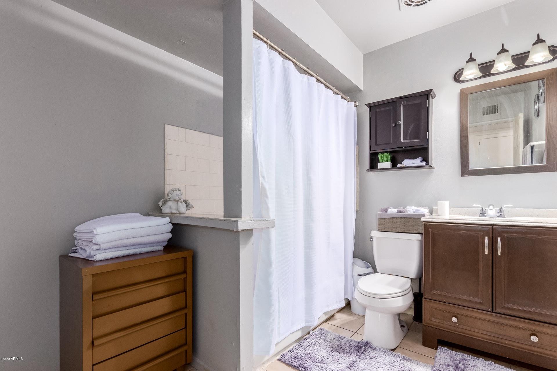 7019 West Camelback Road Phoenix, AZ 85033 - Photo 13 of 25 a bathroom with a sink a toilet and vanity