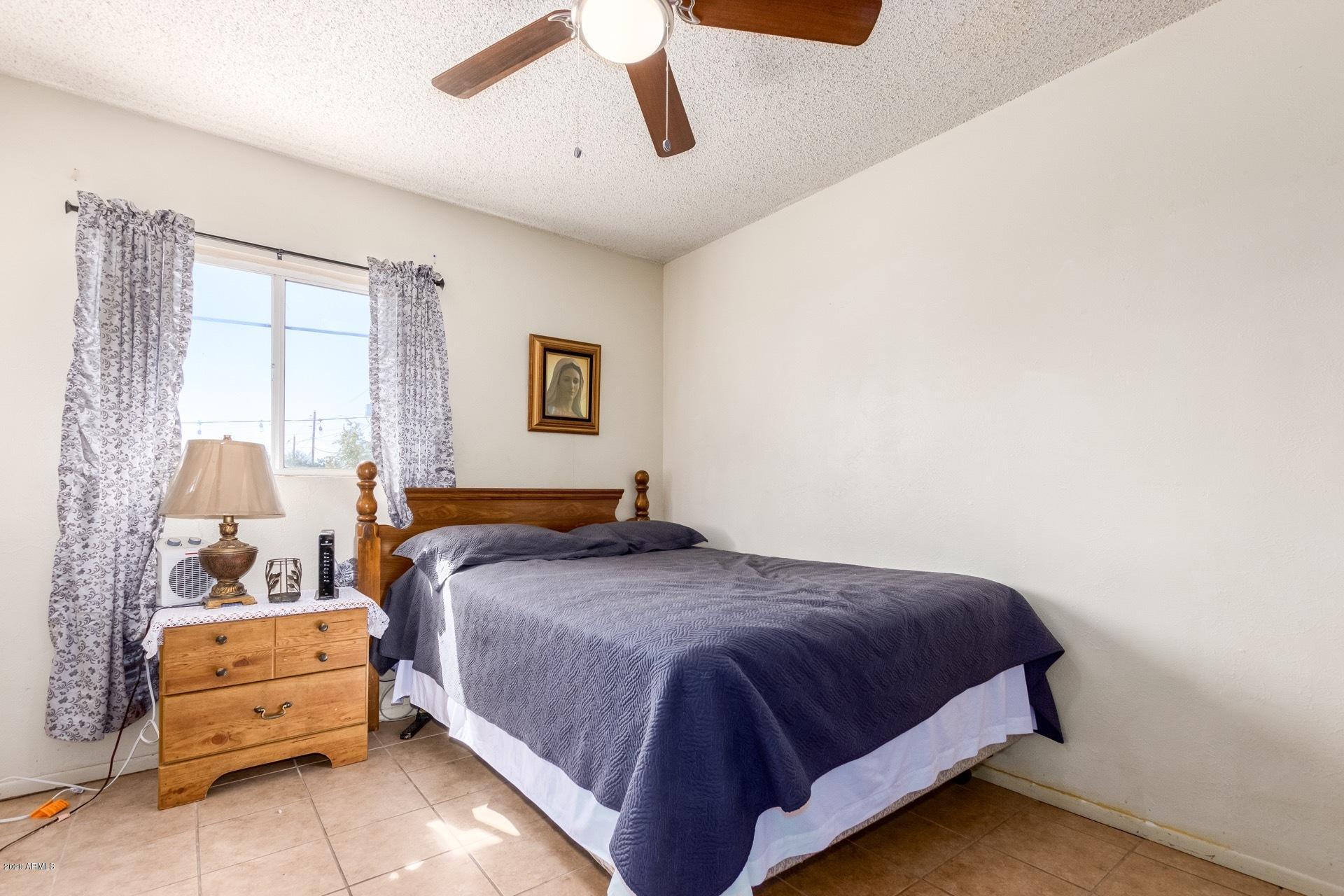 7019 West Camelback Road Phoenix, AZ 85033 - Photo 15 of 25 a bedroom with a bed and window