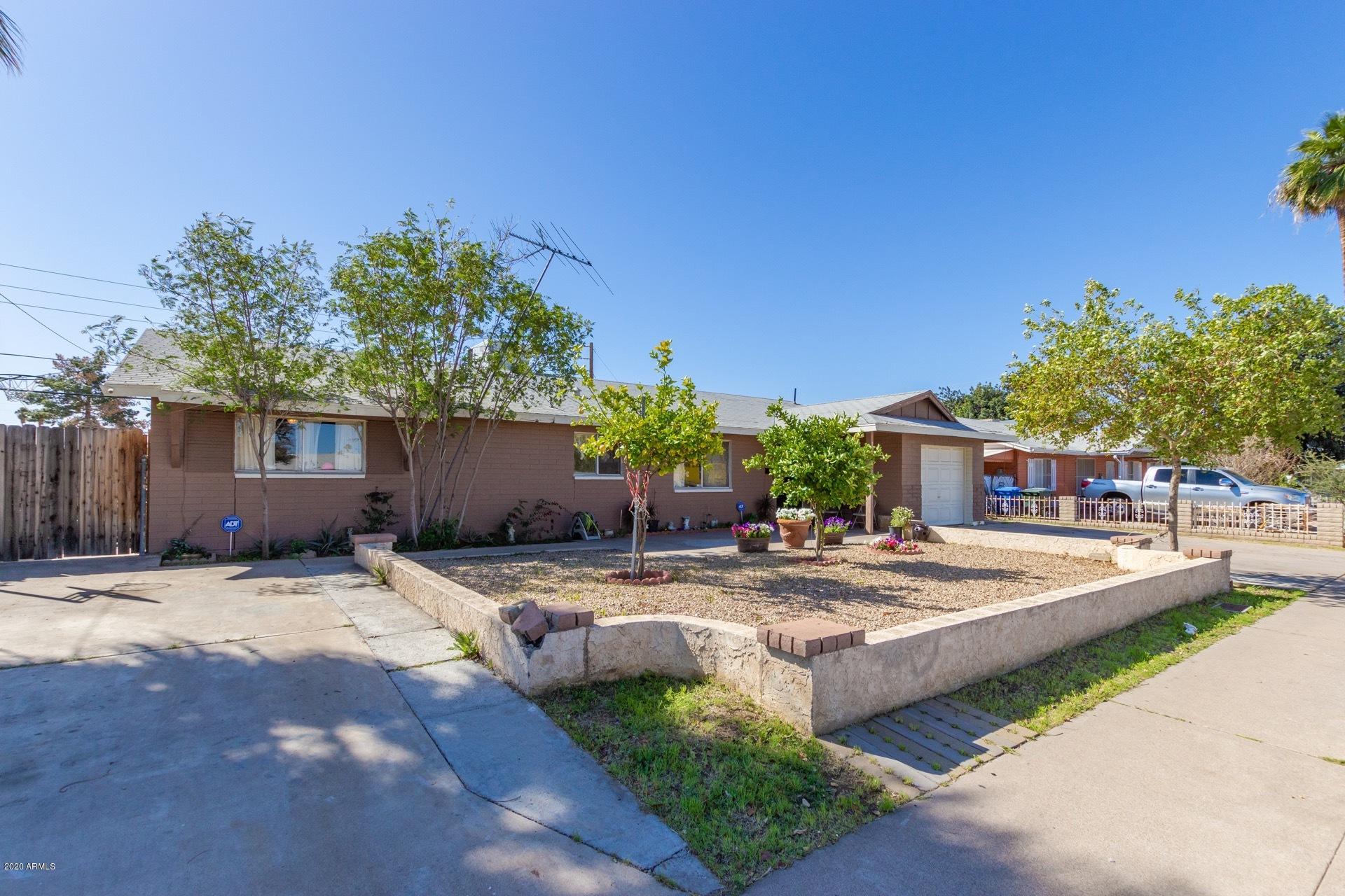 7019 West Camelback Road Phoenix, AZ 85033 - Photo 2 of 25 a wooden bench sitting in front of a house