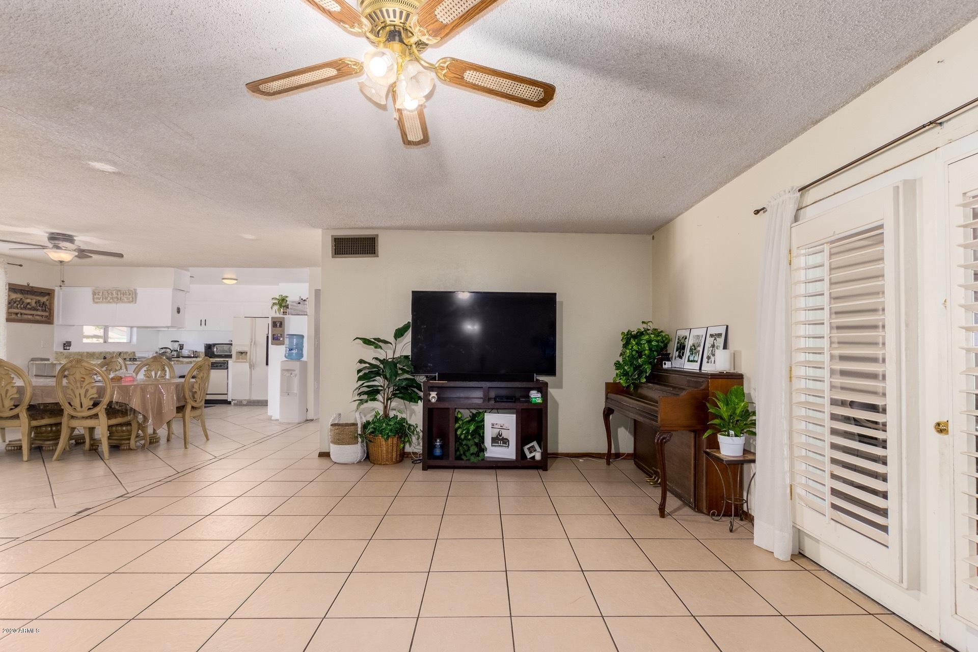 7019 West Camelback Road Phoenix, AZ 85033 - Photo 4 of 25 a living room with furniture and a flat screen tv
