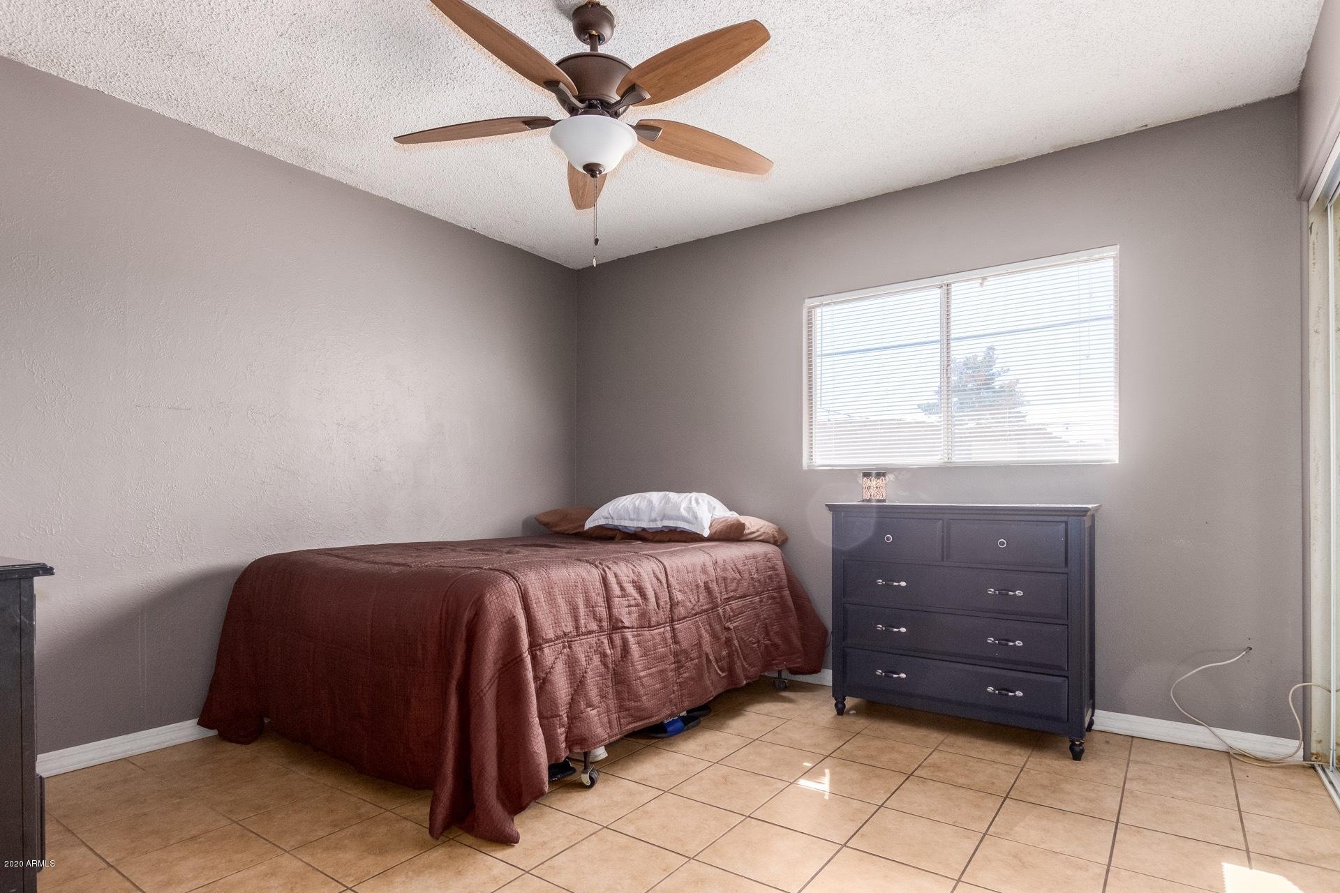 7019 West Camelback Road Phoenix, AZ 85033 - Photo 10 of 25 a bedroom with a bed and a window