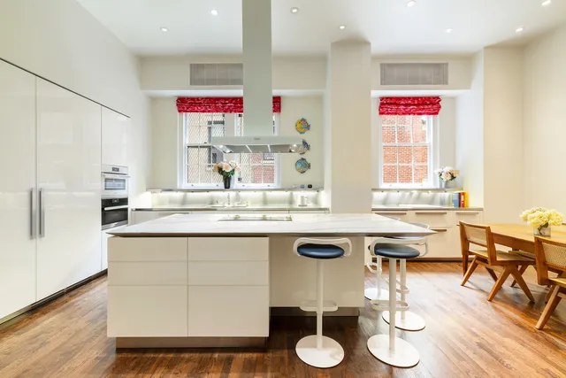 a kitchen with a sink cabinets and wooden floor