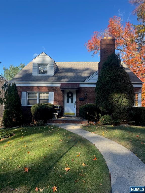 a view of a house with a yard patio and fire pit