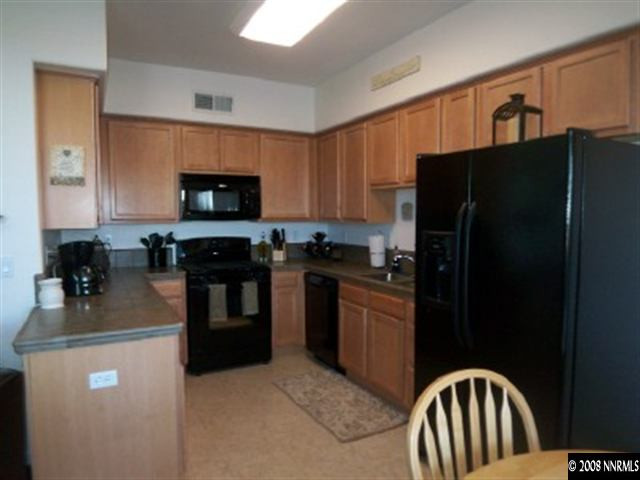 2185 Stanton Lane Reno, NV 89502 - Photo 3 of 9 a kitchen with granite countertop stainless steel appliances and refrigerator