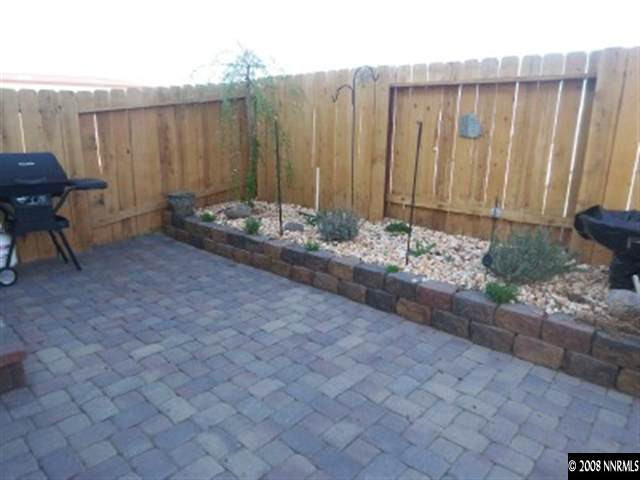 2185 Stanton Lane Reno, NV 89502 - Photo 8 of 9 a view of a backyard with potted plants and a bench