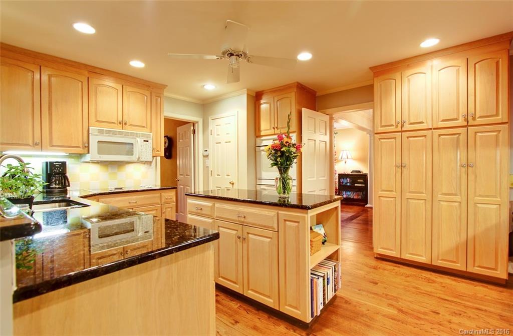 1415 Coventry Road Charlotte, NC 28211 - Photo 5 of 18 a kitchen with stainless steel appliances granite countertop a sink and cabinets