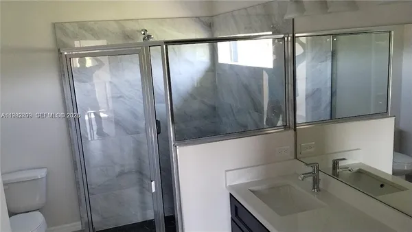 a bathroom with a shower and a sink