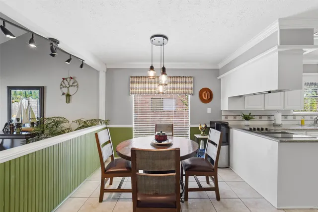 a living room with furniture a fireplace and a floor to ceiling window
