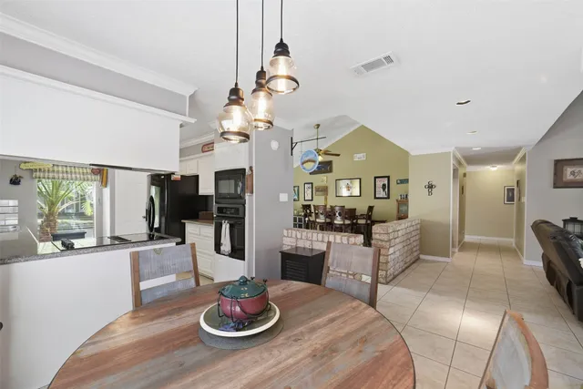 a living room with furniture a fireplace and a potted plant