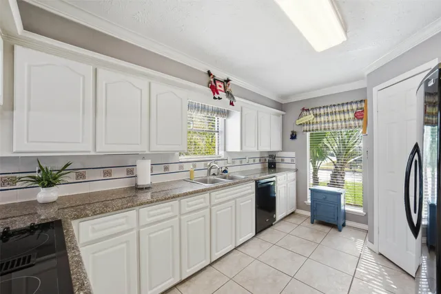 a view of living room with granite countertop furniture and floor to ceiling window