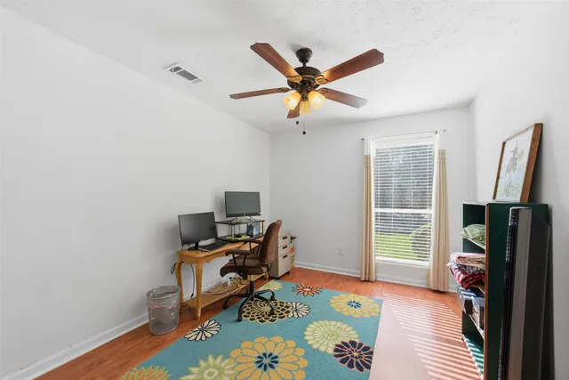 a bathroom with a granite countertop double vanity sink and a mirror