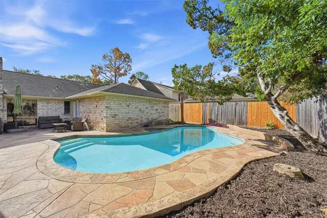 a view of a swimming pool in the backyard