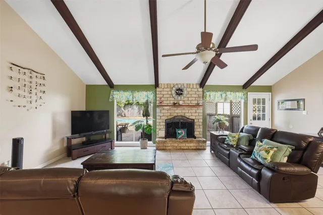 a living room with furniture a flat screen tv and a fireplace