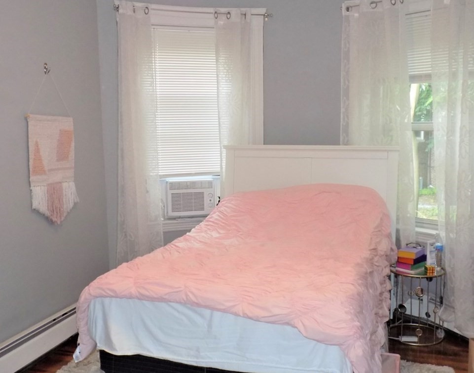 19 University Road, Unit 3 Brookline, MA 02445 - Photo 15 of 16 a bedroom with a bed and a window