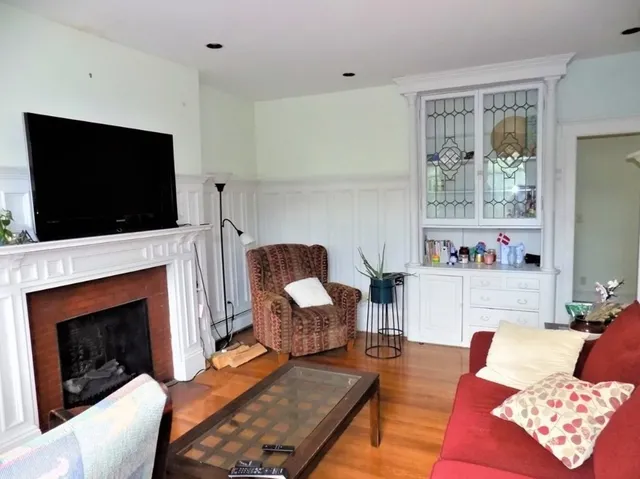 a living room with furniture fireplace and flat screen tv