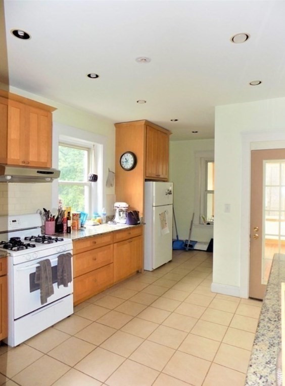 19 University Road, Unit 3 Brookline, MA 02445 - Photo 7 of 16 a kitchen with stainless steel appliances a stove a sink and a refrigerator