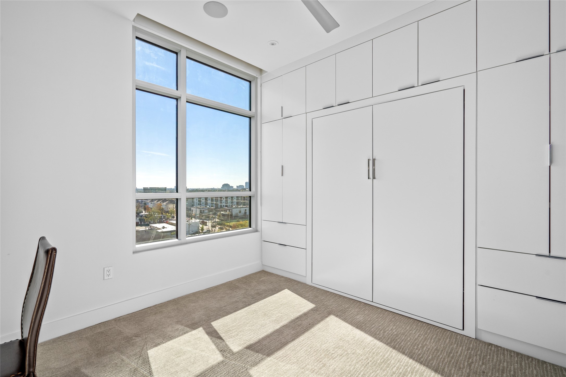 3331 D'Amico Street, Unit 904 Houston, TX 77019 - Photo 15 of 21 Featuring a built-in Murphy bed, ample storage, window coverings, and integrated Savant surround sound, this secondary bedroom combines functionality with modern conveniences.