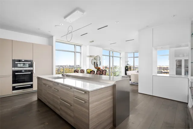 a view of living room with stainless steel appliances granite countertop furniture and a window