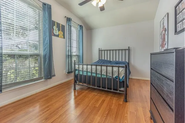 a view of a room with wooden floor and windows