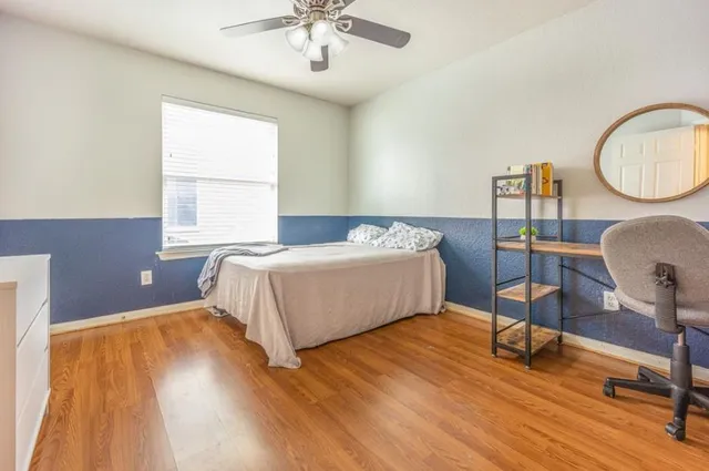 a bed room with a bed and a chair